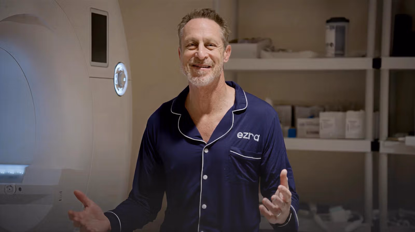 Mark Hyman sitting on an MRI machine talking to the camera.